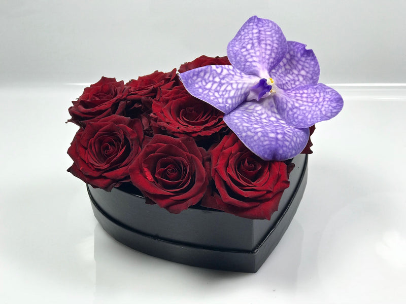 Cuore con rose rosse e fiore di orchidea